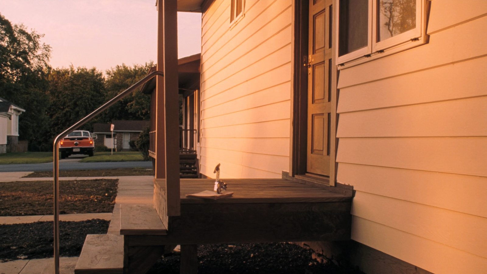 Bright, well-maintained single-family rental home with green lawn and clear blue sky representing an income property being screened by gross rent multiplier in 2026
