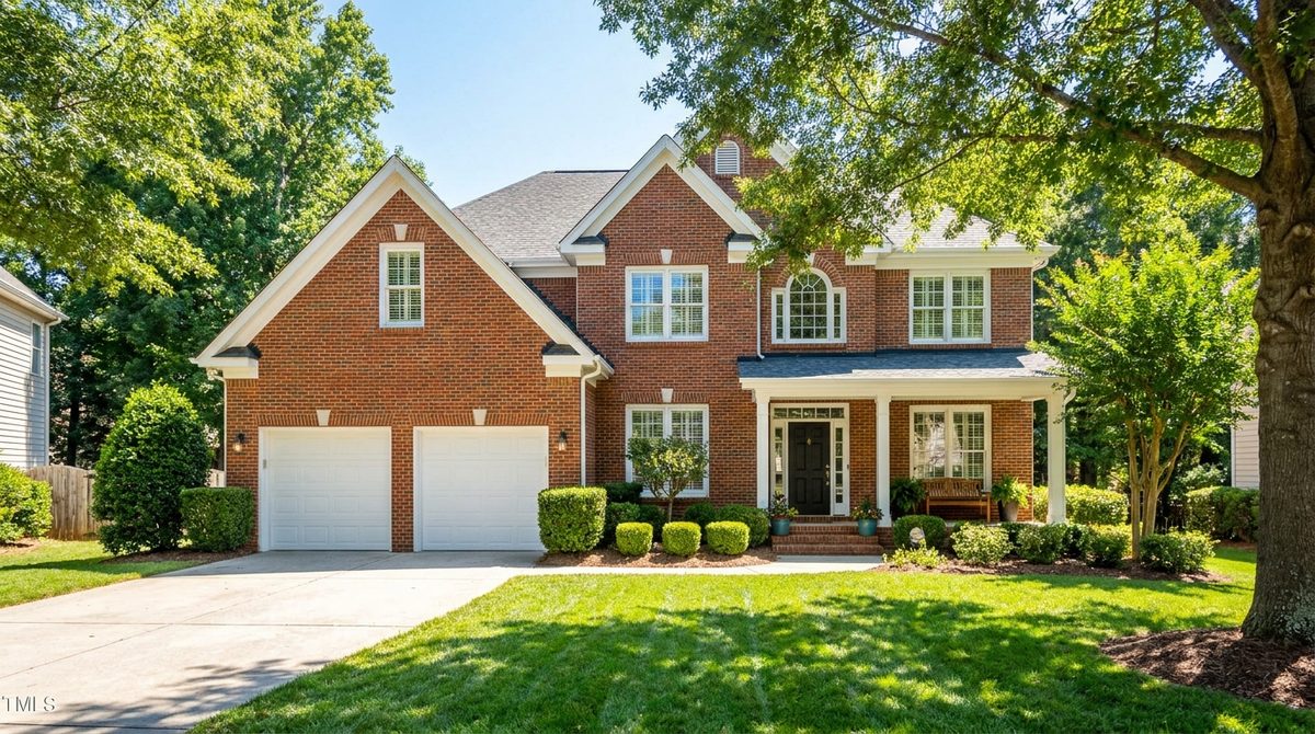 Renovated brick bungalow in a Charlotte, NC Plaza Midwood neighborhood at golden hour, typical 2026 cash-buyer target inventory in Mecklenburg County